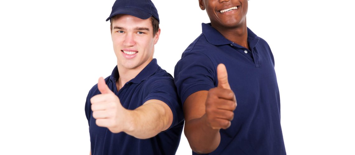 two blue collar co-workers giving thumbs up